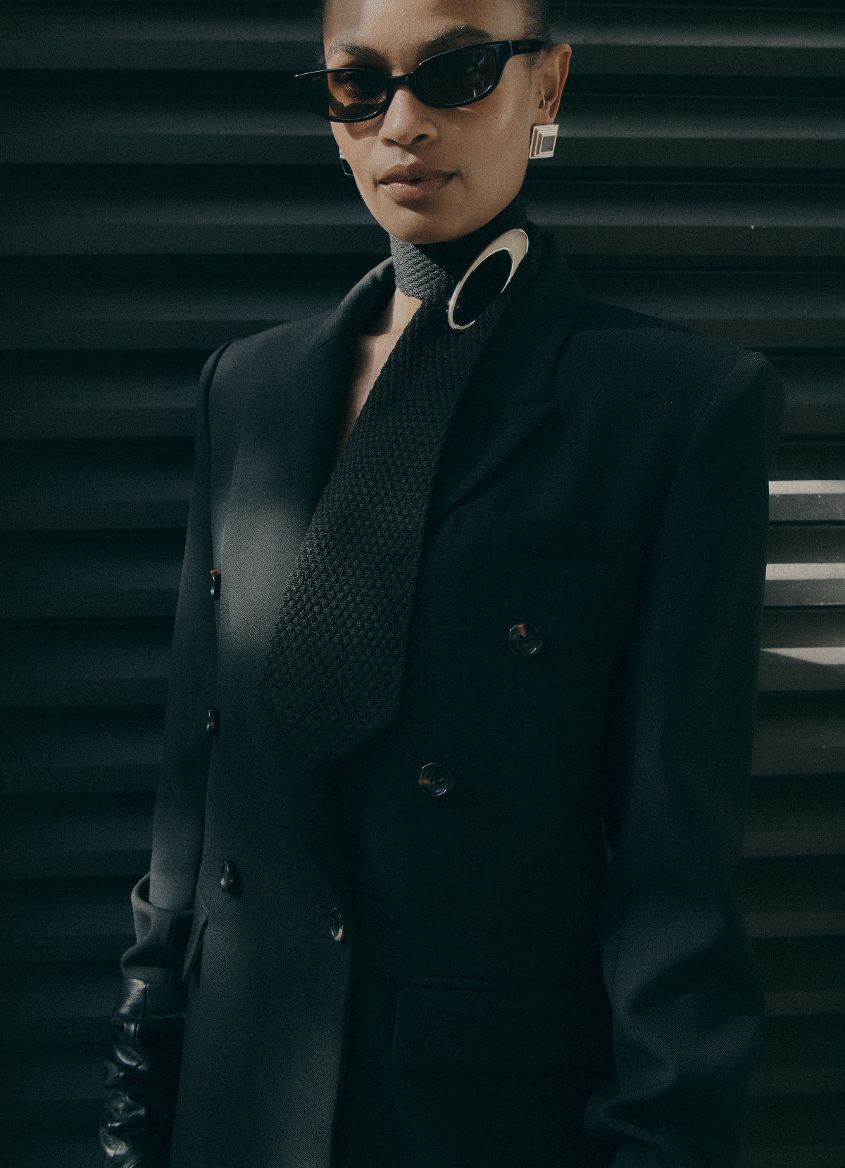 Close-up of black wool double-breasted blazer detailing, from de Savary London.