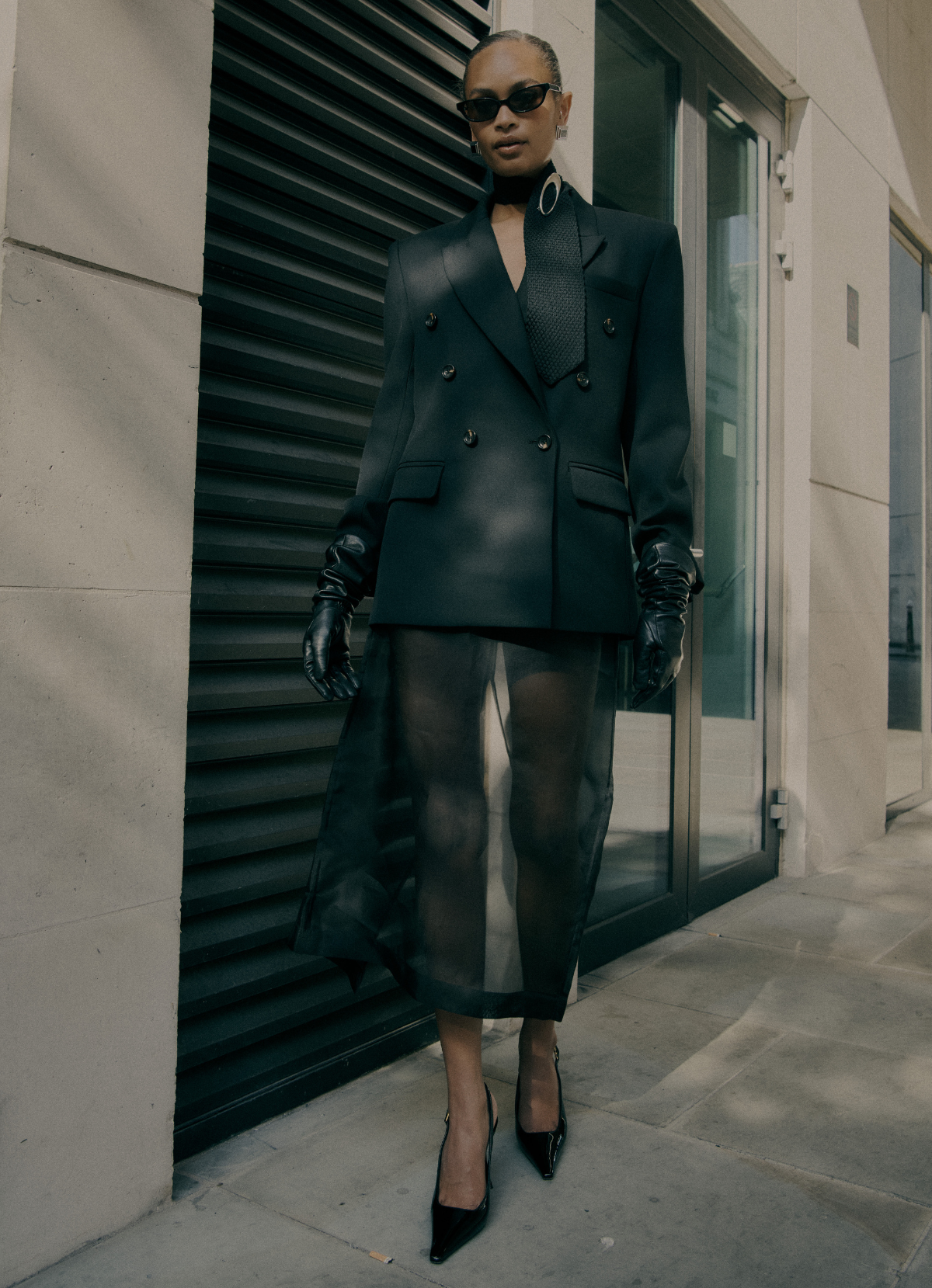 Model wearing black wool double-breasted blazer from de Savary London.